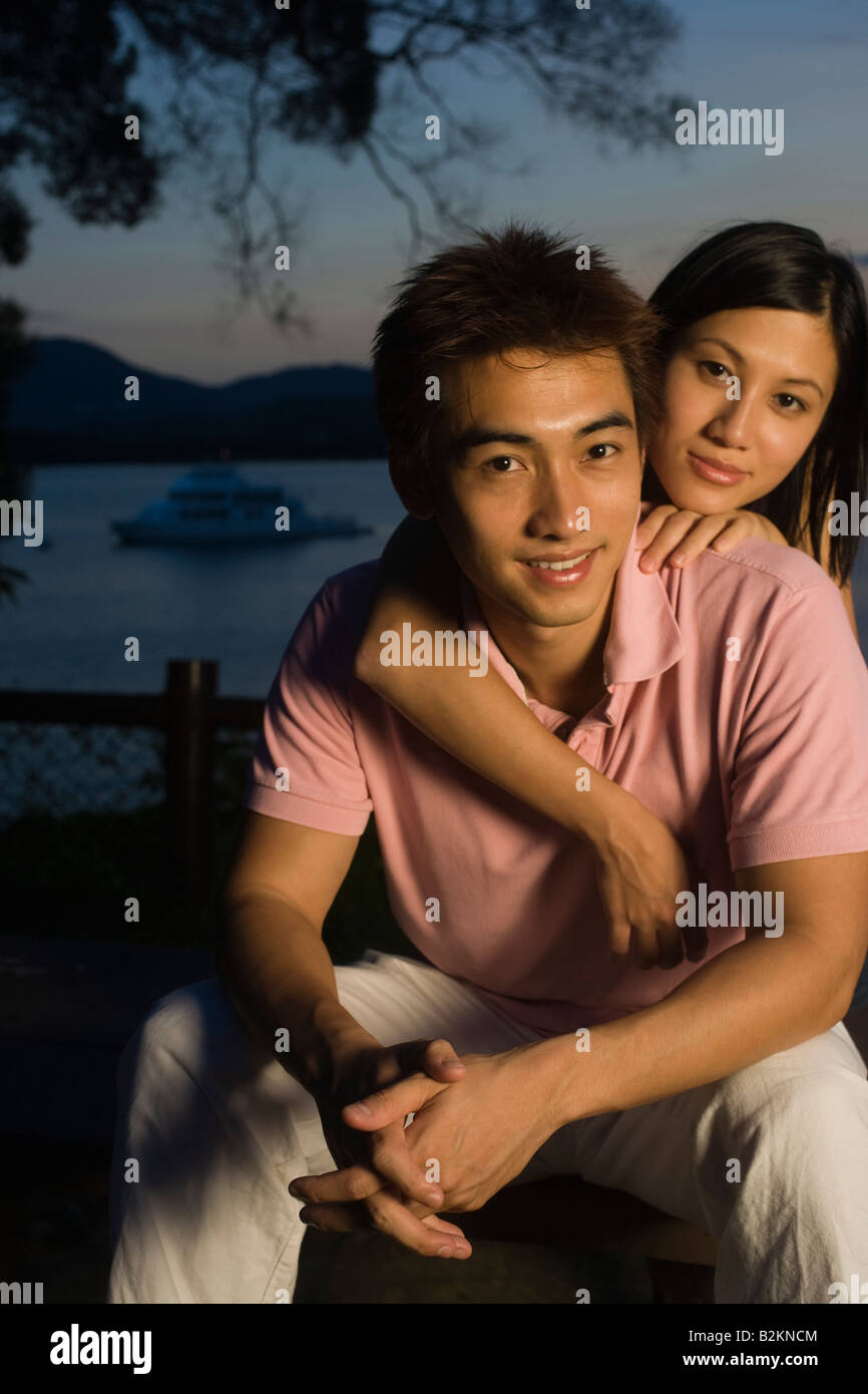 Mid adult woman embracing a young man from behind Stock Photo - Alamy