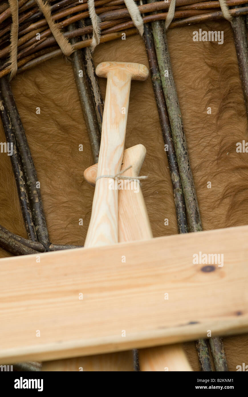 Two paddles lay in a coracle traditionally made with a cow hide. Stock Photo