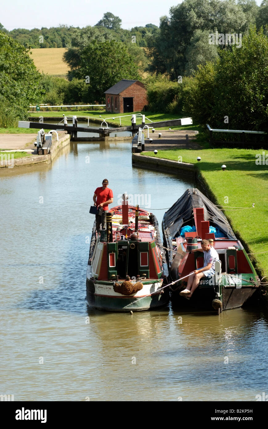 Working canal boats on the Grand Union Canal at Stoke Bruerne in the English countryside Northamptonshire England Stock Photo