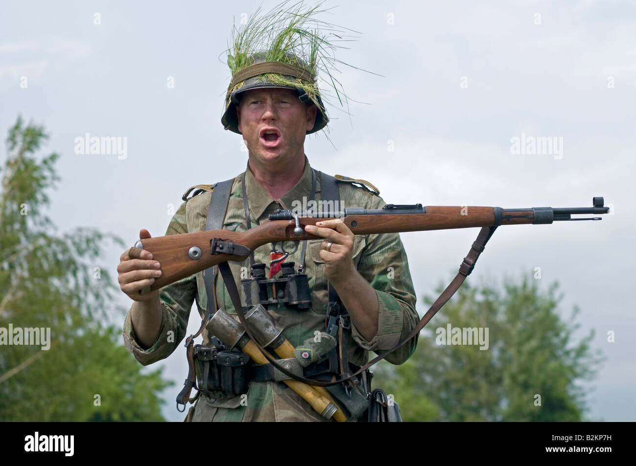 A German army Unteroffizier giving ad hoc training for field tactics to new troops Stock Photo