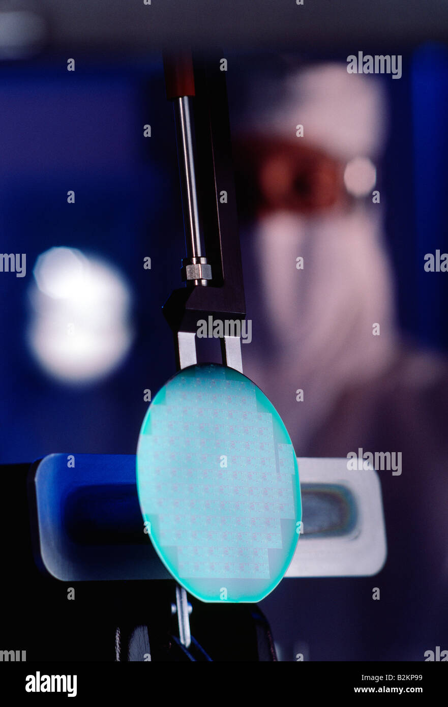 Technician and silicon wafer in clean room environment, used in the manufacturing of computer chips Stock Photo