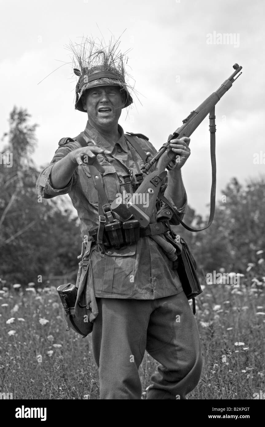 A German army Unteroffizier giving ad hoc training for field tactics to new troops Stock Photo