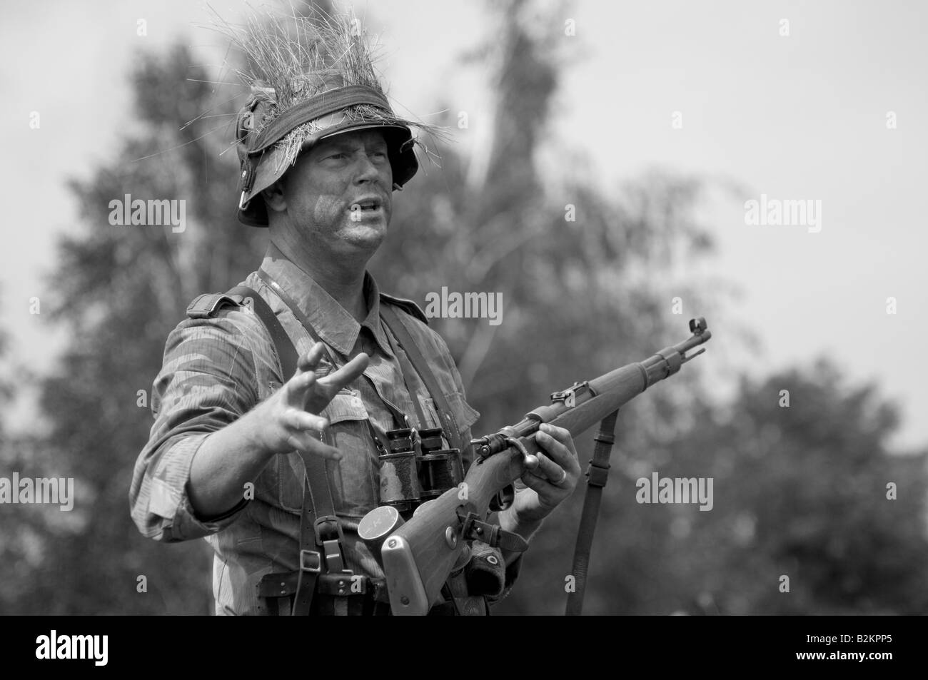 A German army Unteroffizier giving ad hoc training for field tactics to new troops Stock Photo