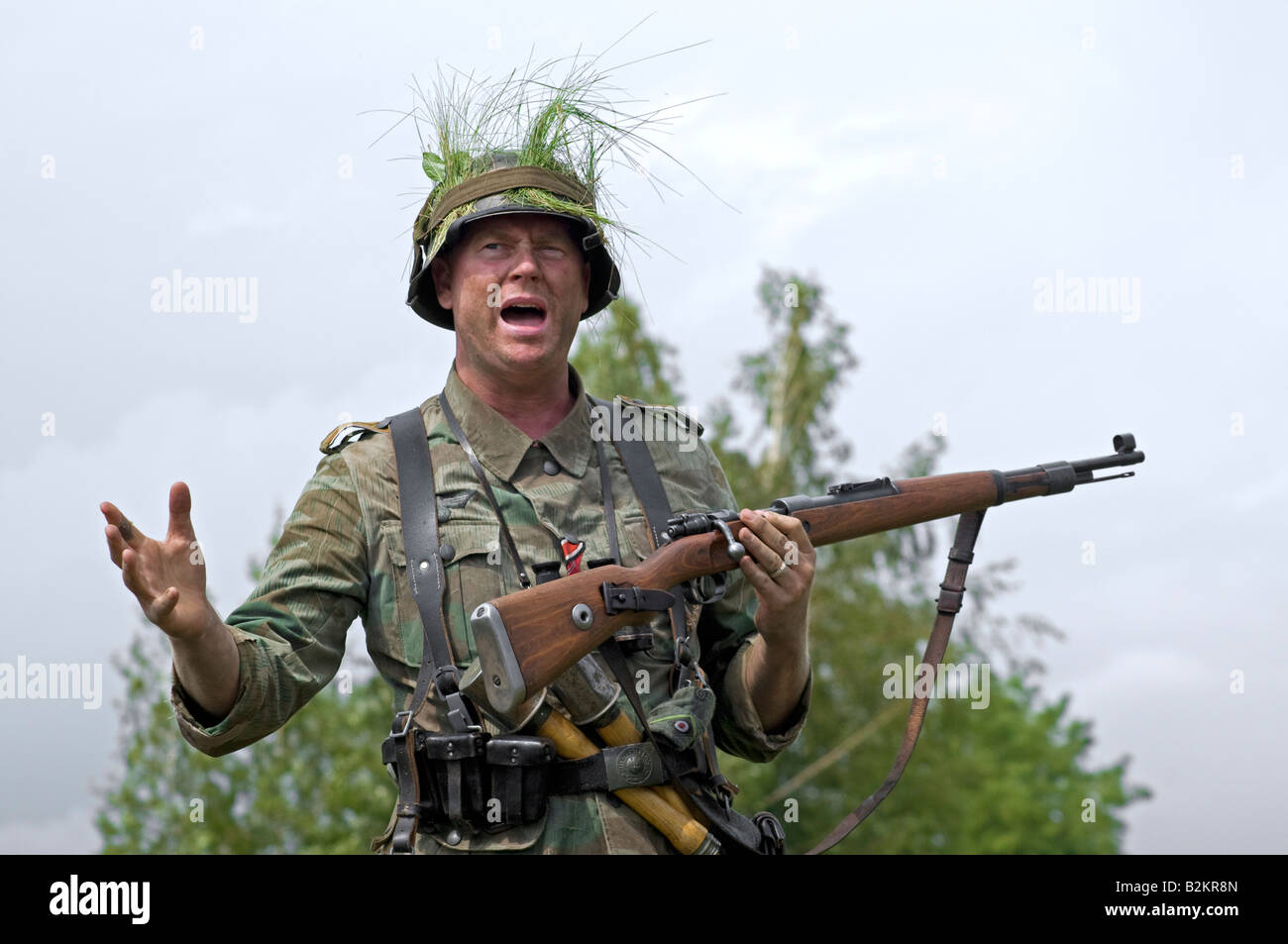 A German army Unteroffizier giving ad hoc training for field tactics to new troops Stock Photo