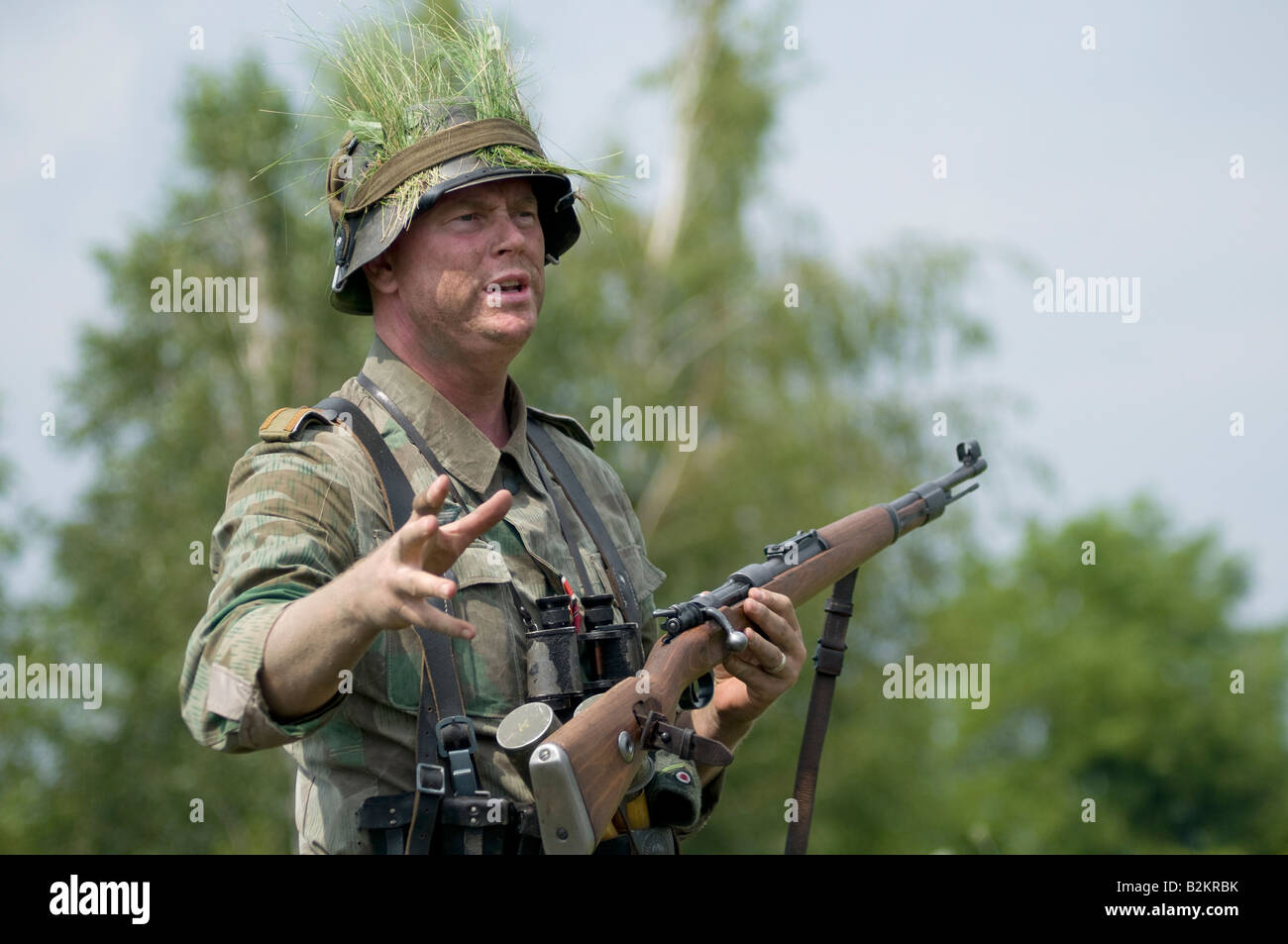 A German army Unteroffizier giving ad hoc training for field tactics to new troops Stock Photo