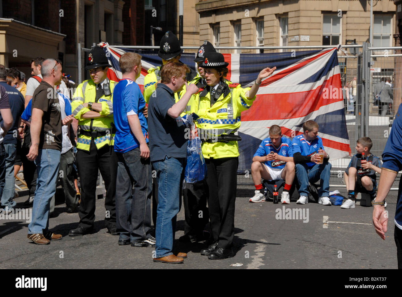 Police officers give directions to Glasgow rangers football fans on the day of the Euro final, 2008 in Manchester. Stock Photo