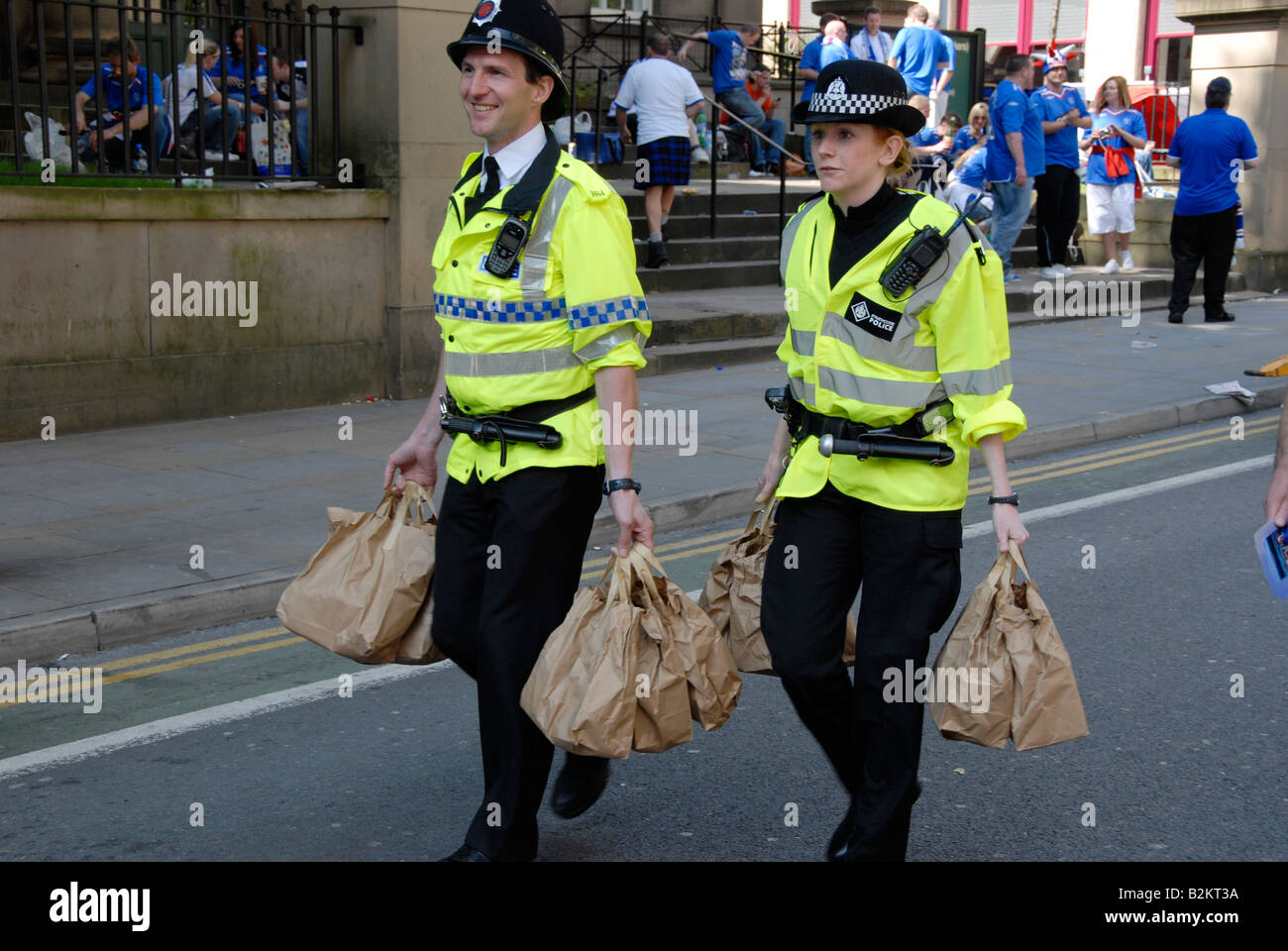 Police officers with takeaways as they police the crowds of glasgow rangers gathering in manchester for the euro final 2008. Stock Photo