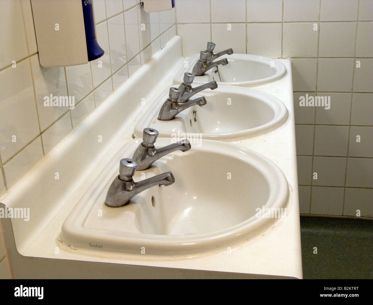 Wash basins in a Gents toilet in England UK Stock Photo Alamy