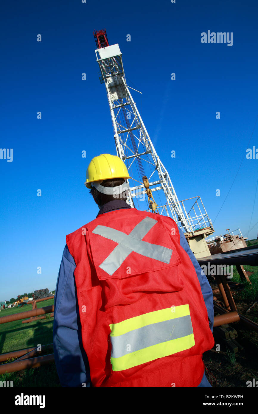 Oil drilling rig with workman in Alberta Canada Stock Photo Alamy