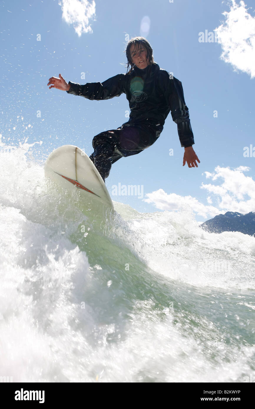 wave surfing behind a boat on green lake in whistler British Columbia