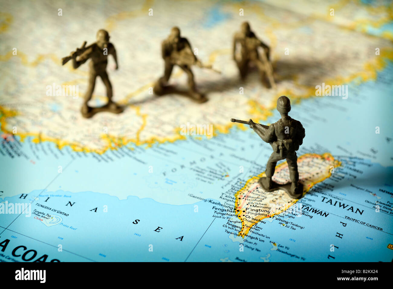 Toy soldiers on map of China and Taiwan face off against each other Stock Photo