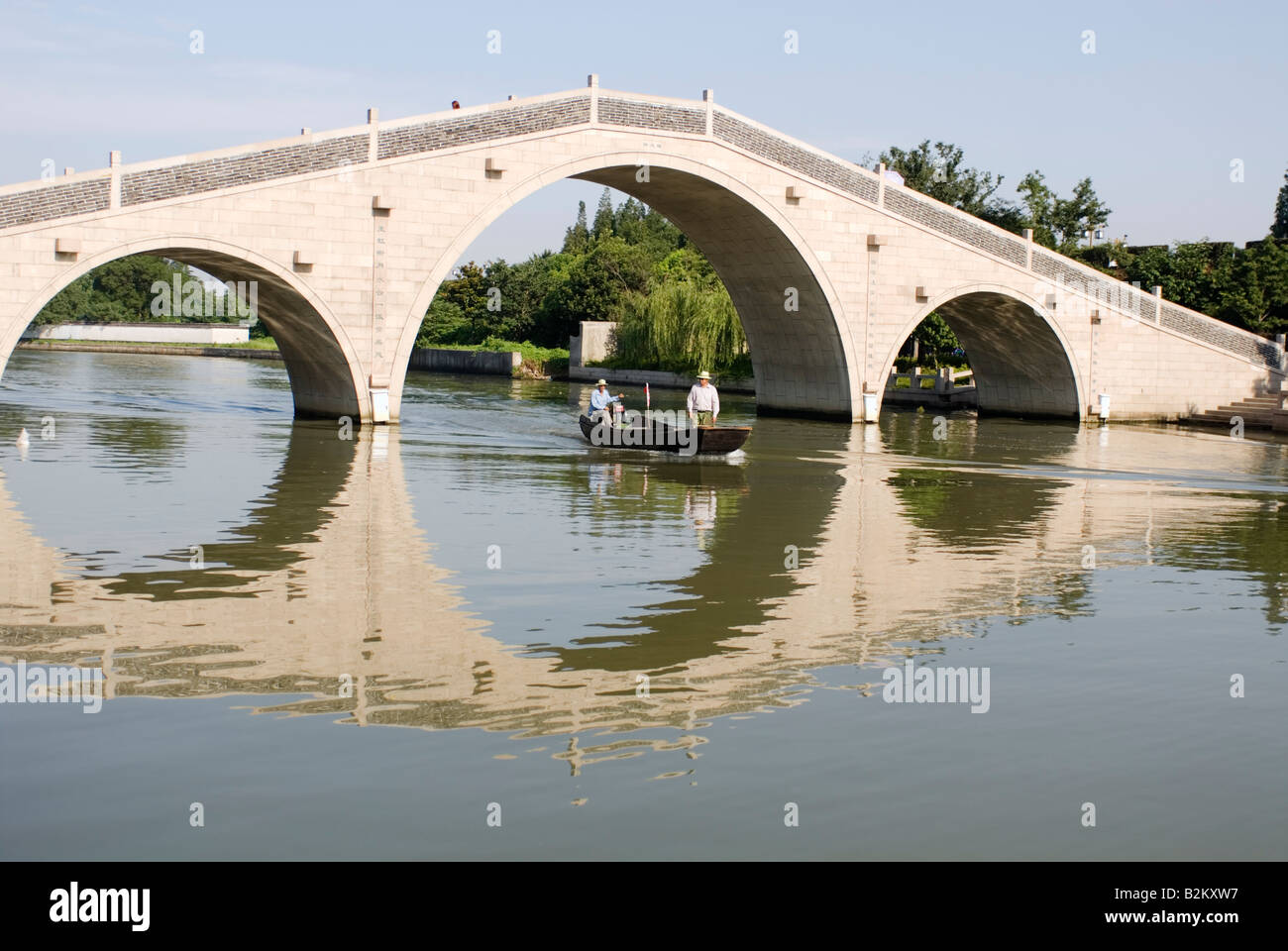 China, Suzhou, Boating Under Stone Bridge On The Grand Canal Stock Photo