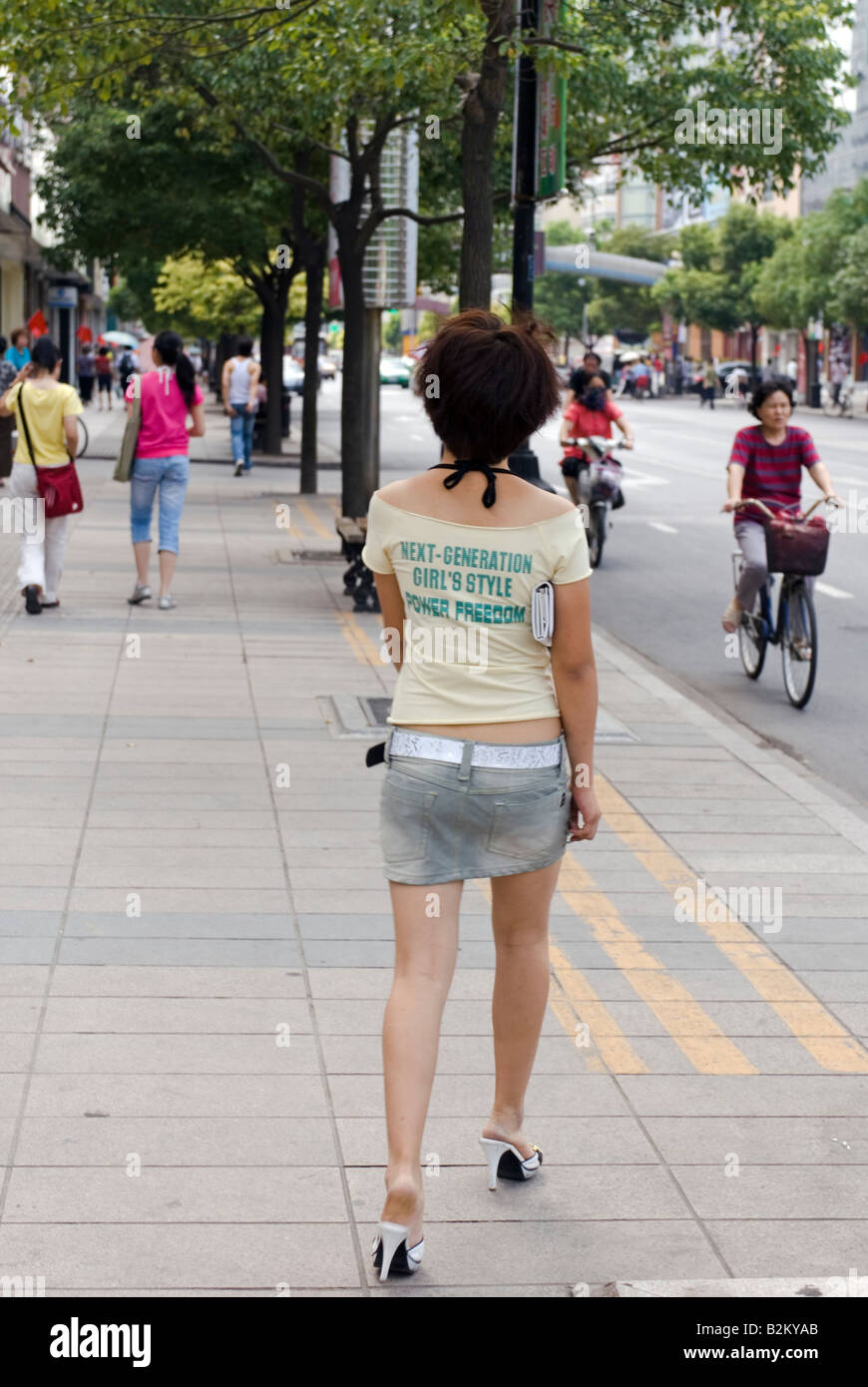 Modern Chinese Girl Walking Down The Street, Nanjing, China Stock Photo