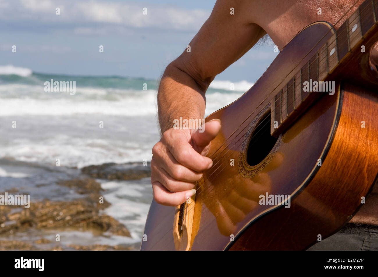 Playing guitar against a backdrop of the sea Stock Photo Alamy