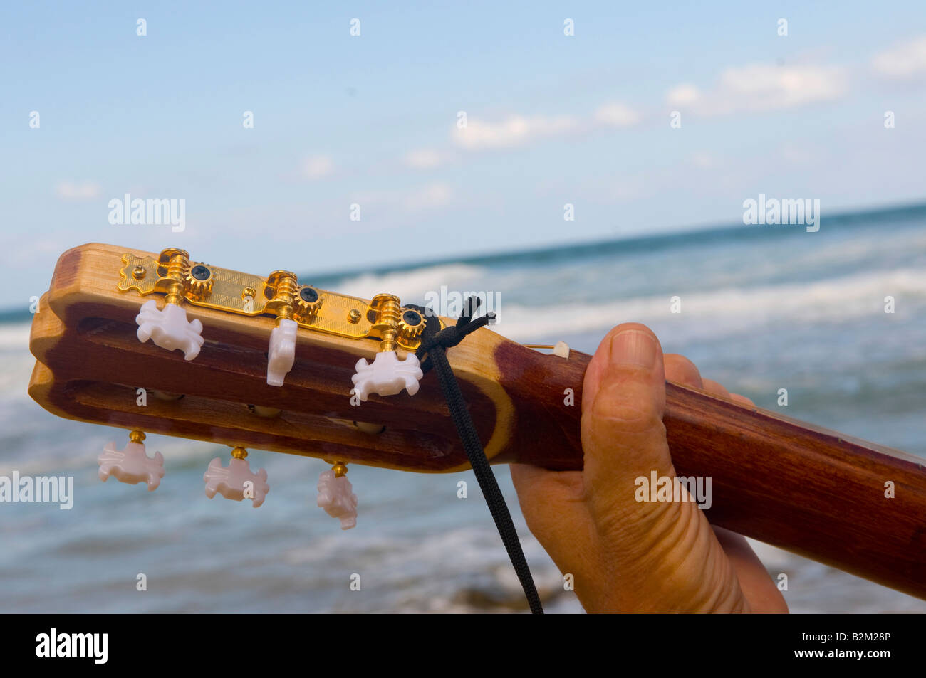 Guitar neck against the backdrop of the sea Stock Photo