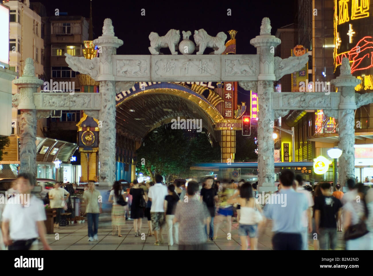 China, Nanjing, Hunan Road old stone gateway to pedestrian area at night Stock Photo