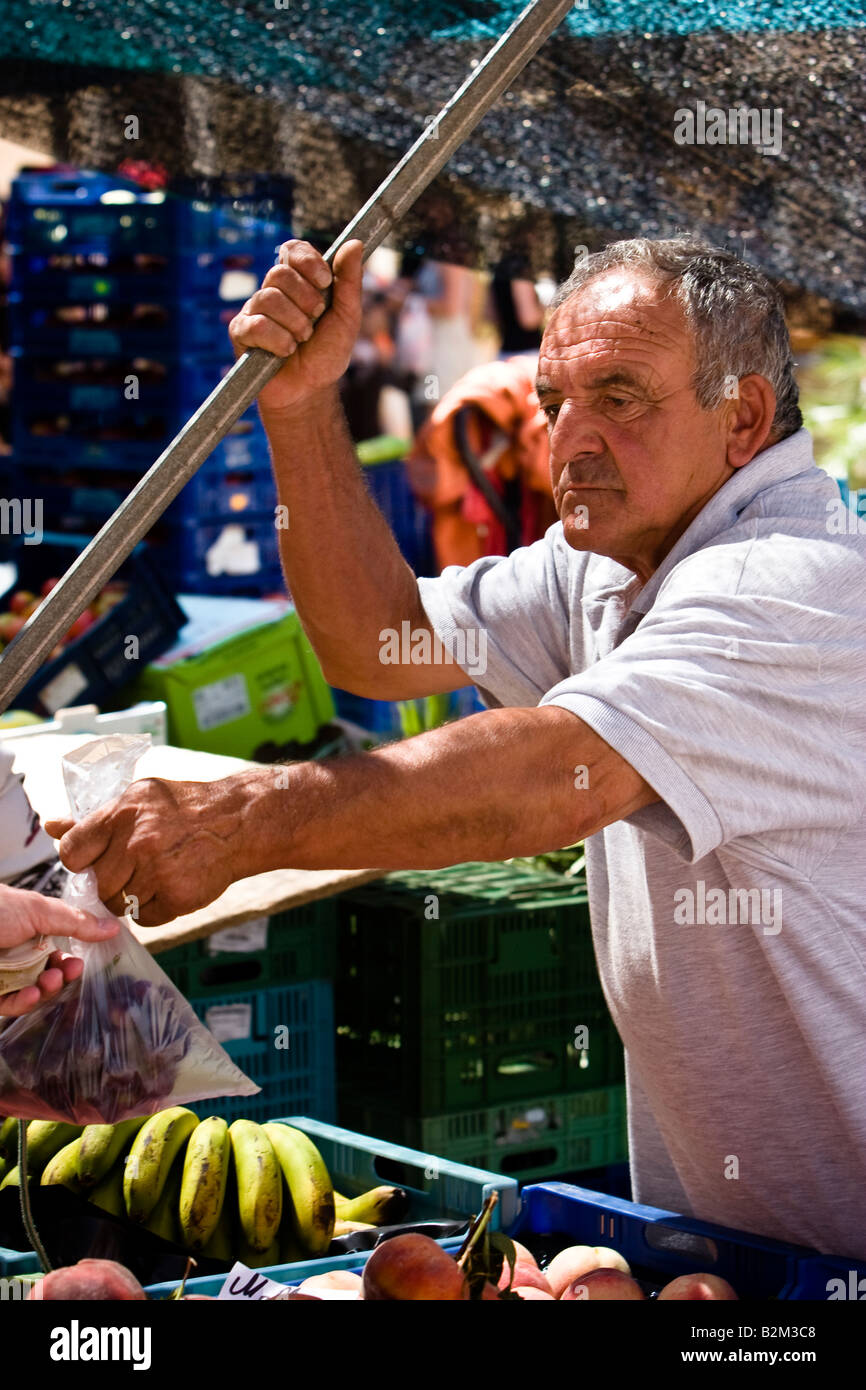 Man sells grapes at the farmer s market in Sineu, Majorca, Balearic Islands, Spain Stock Photo