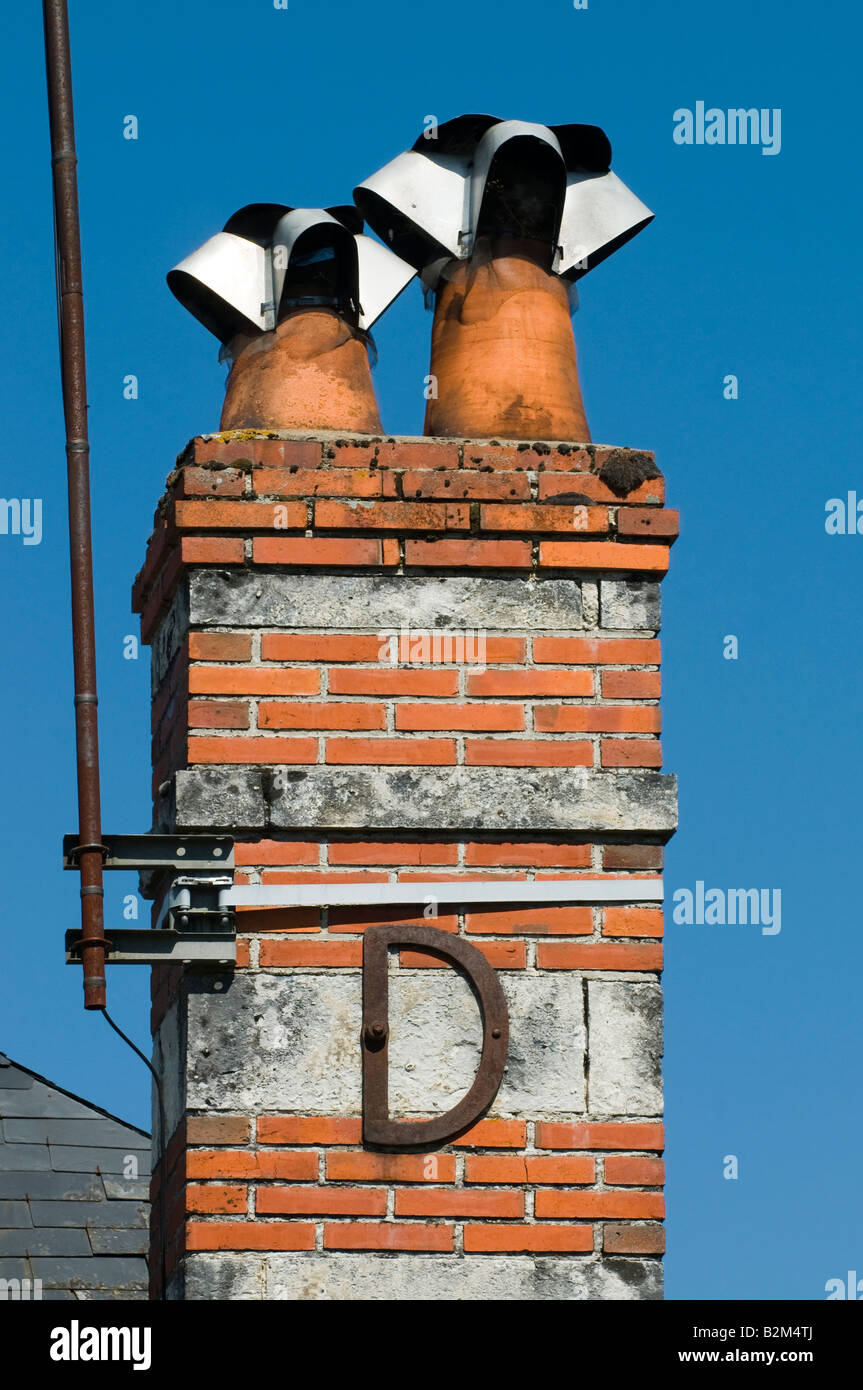 Decorative letter "D" reinforcing chimney stack, France. Stock Photo