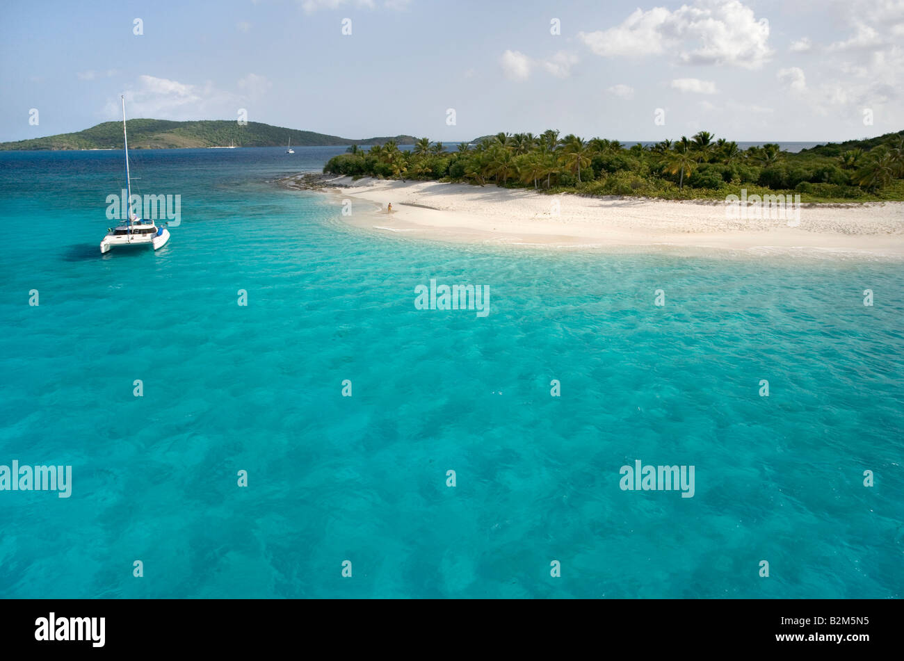 A cruising catamaran anchored next to uninhabited Sandy Cay in the British Virgin Islands. Stock Photo