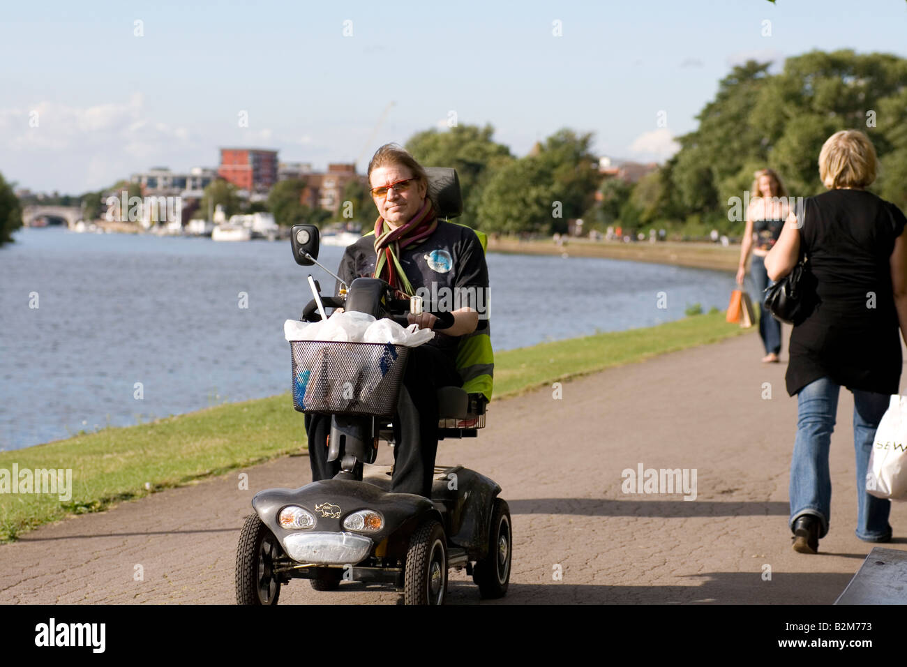 A motorised wheelchair on the path next to the Thames near Kingston
