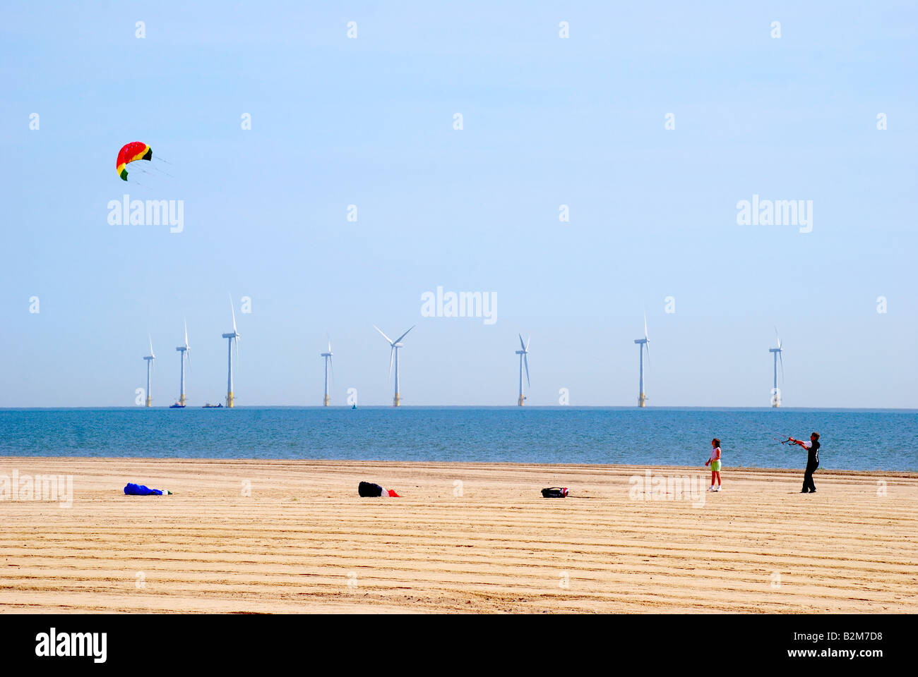 Kite flying on Great Yarmouth Beach showing offshore wind turbines,  Great Yarmouth, Norfolk, England, United Kingdom Stock Photo