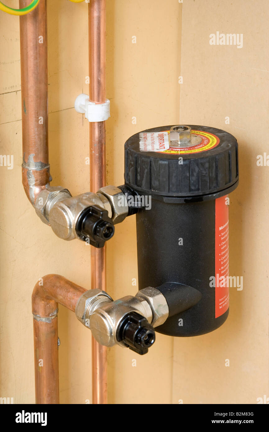 magnetic filter to remove iron oxide sludge from heating system pipe Stock Photo