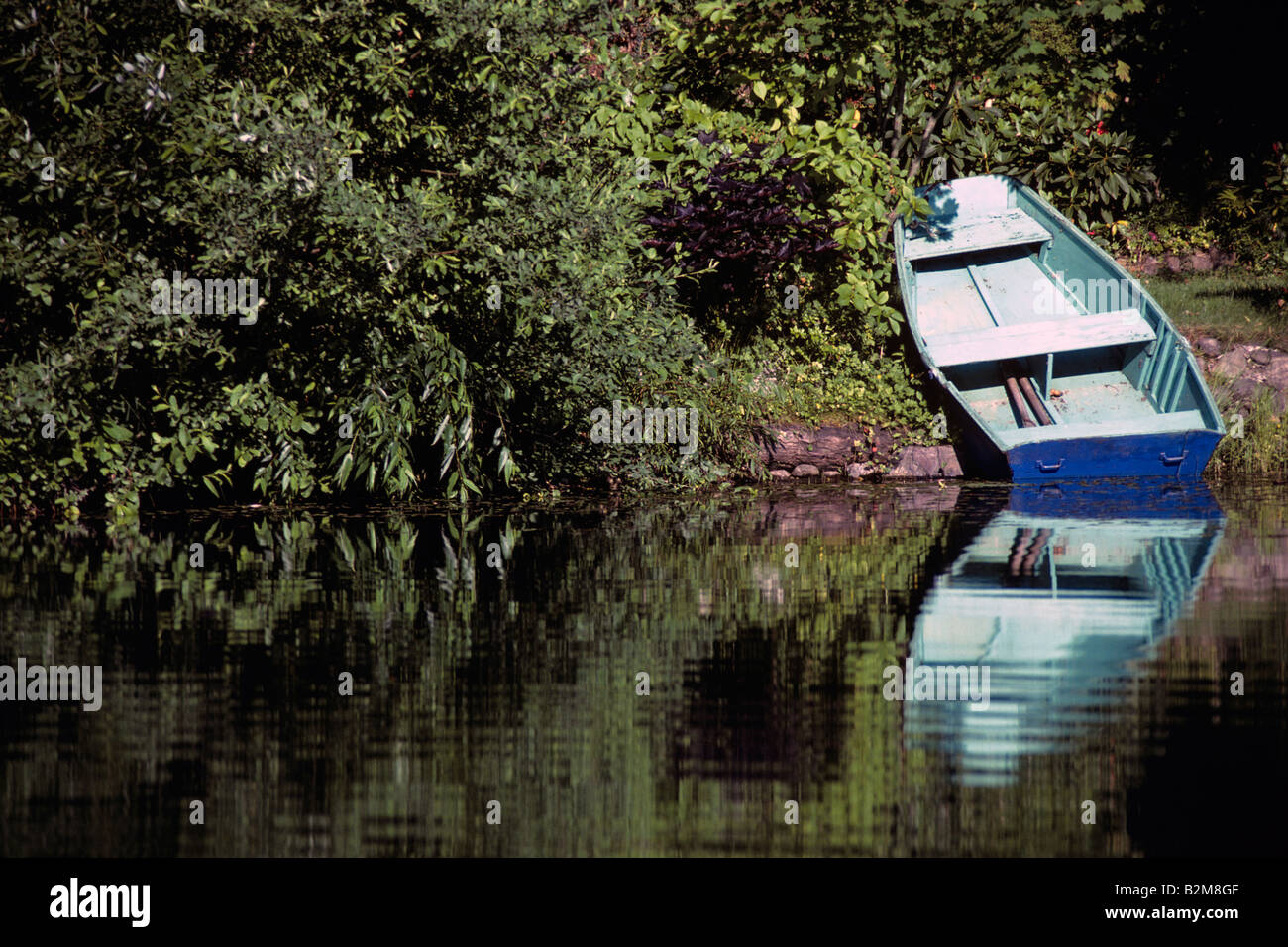 Rowboat pulled up onto shoreline on Lake Mason Olympic Penninsula Washington State USA Stock Photo
