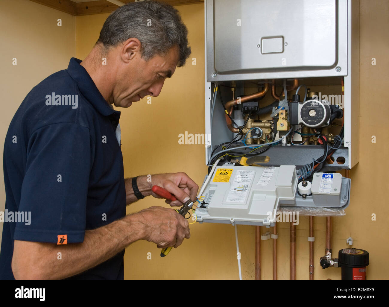 man working on a gas boiler Stock Photo
