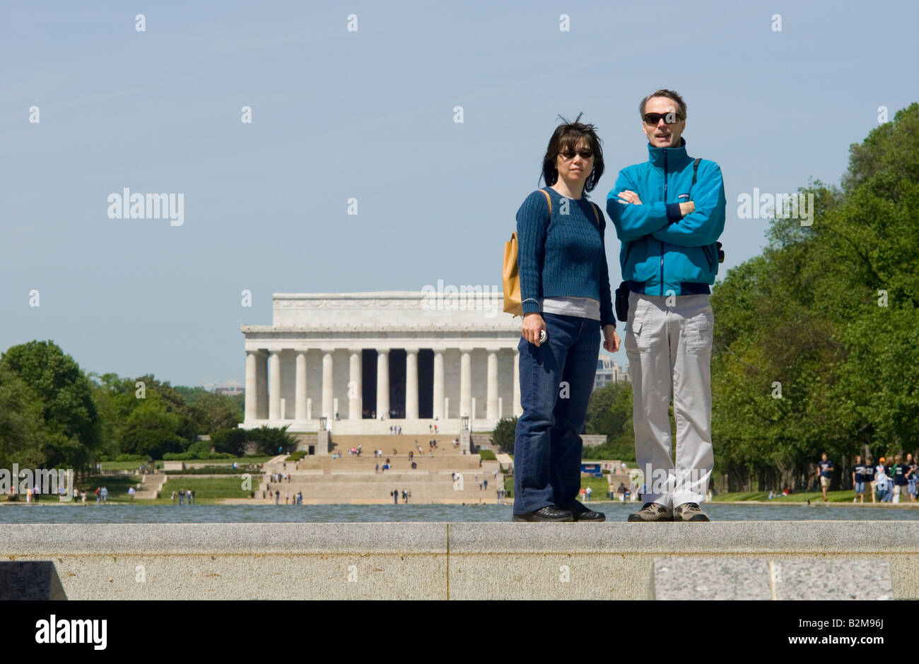Tourists in Washington DC looking toward World War II memorial with Lincoln Memorial in background Stock Photo