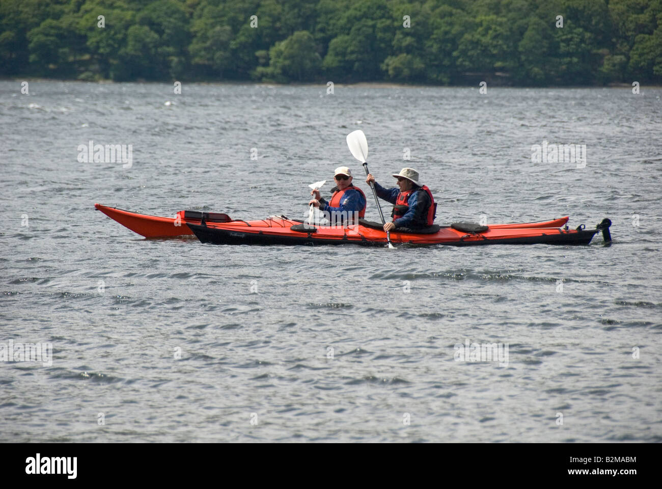 Two men in kayaks, Derwent Water, Lake District National Park, Cumbria, England, UK Stock Photo