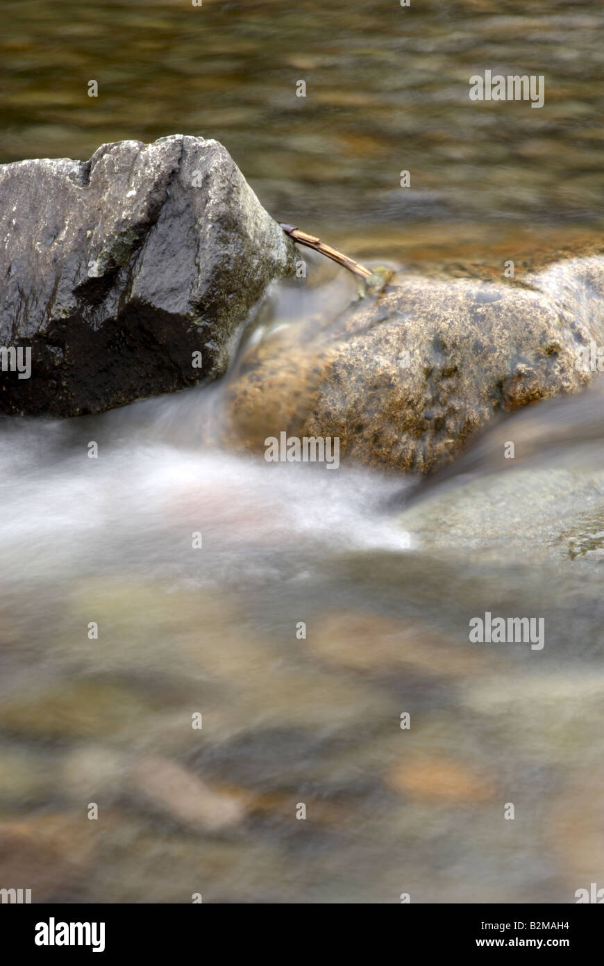 Water flowing over stones in a river bed Stock Photo