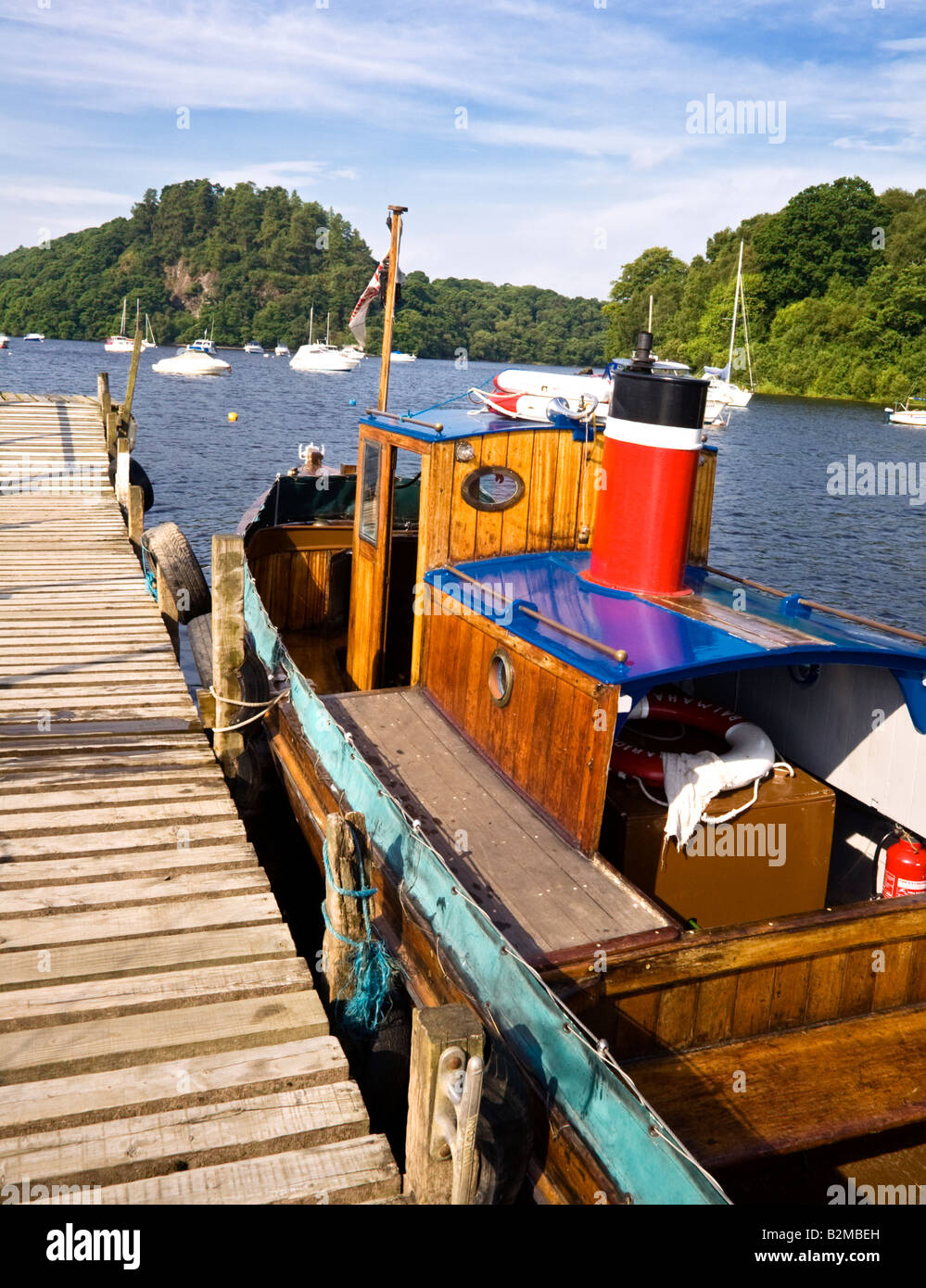 An old wooden boat moored beside a jetty at Balmaha, Loch Lomond ...