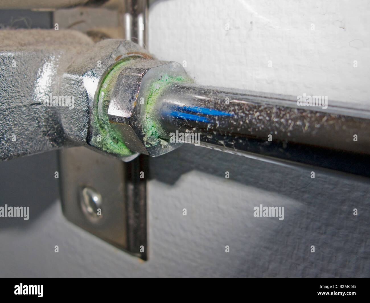 Micro leakage from a water pipe showing green corrosion Stock Photo