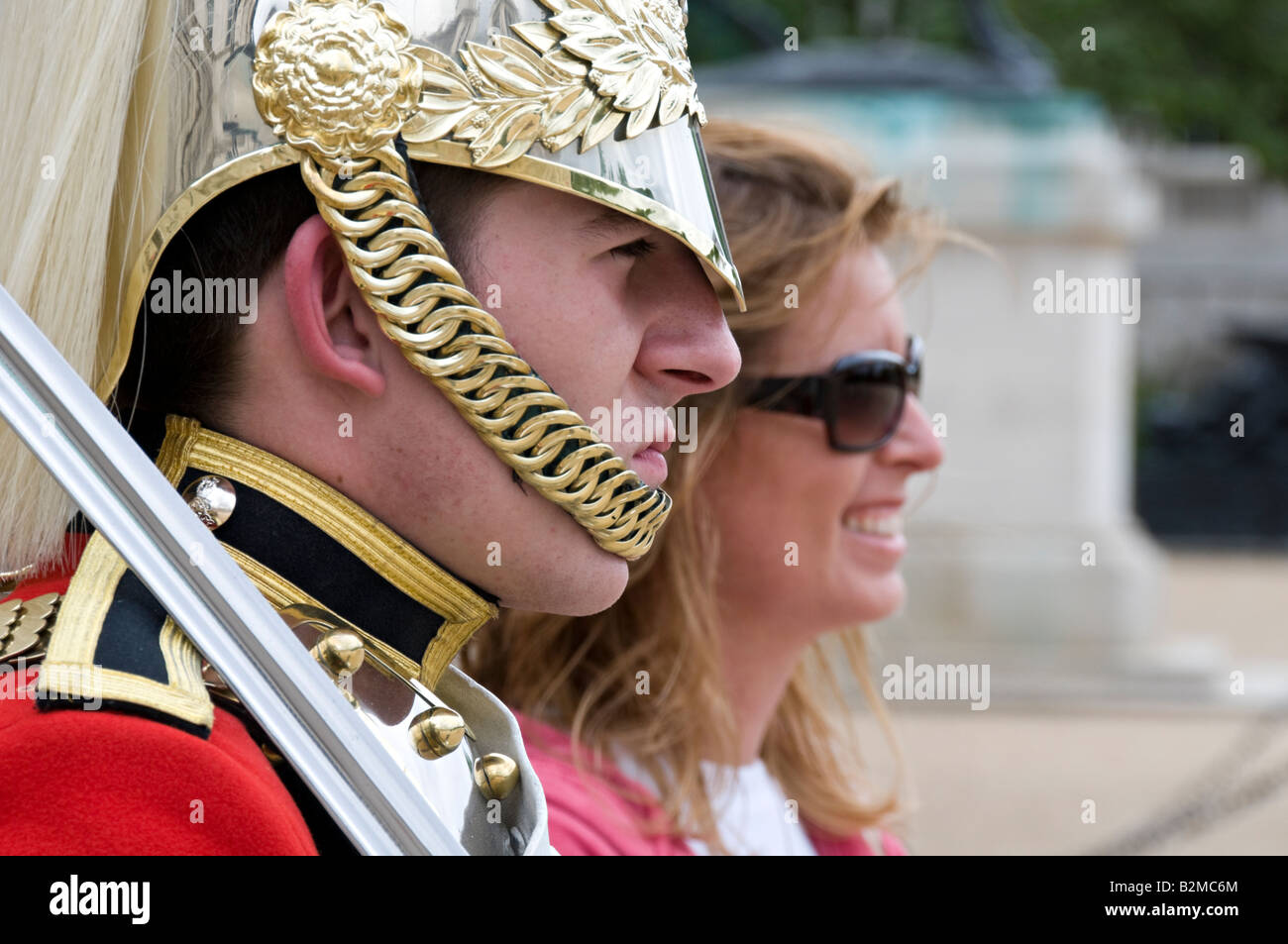 Tourist posing with horse guard in Horse Guards Parade ceremonial grounds, Whitehall, London Stock Photo