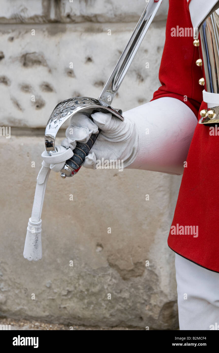 Horse guard holding a sword while on duty in the Horse Guards Parade, Whitehall, London Stock Photo