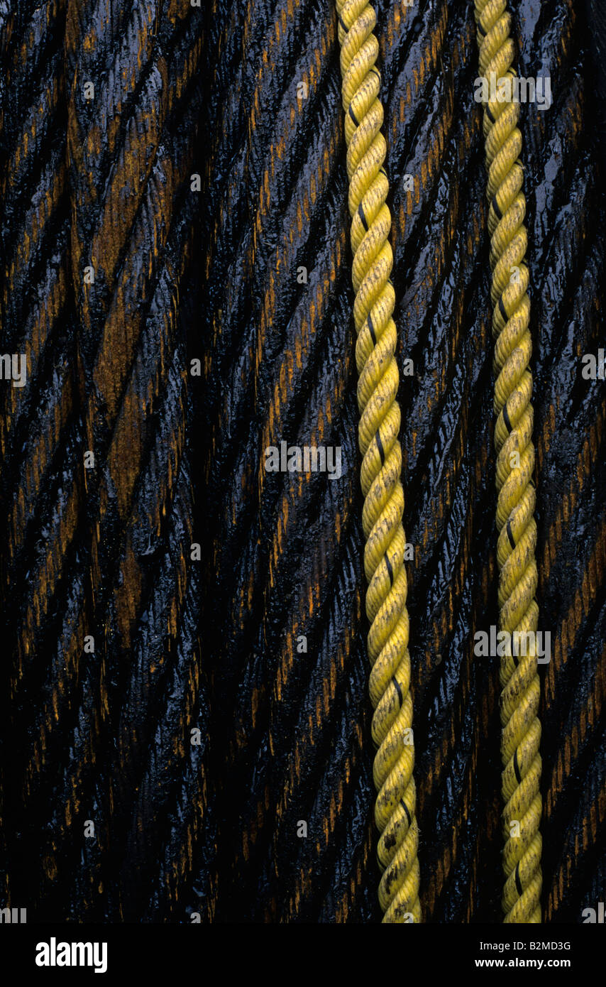 Close up of rusting oily steel cable with yellow ropes Industrial area in downtown Ballard Seattle Washington State USA Stock Photo