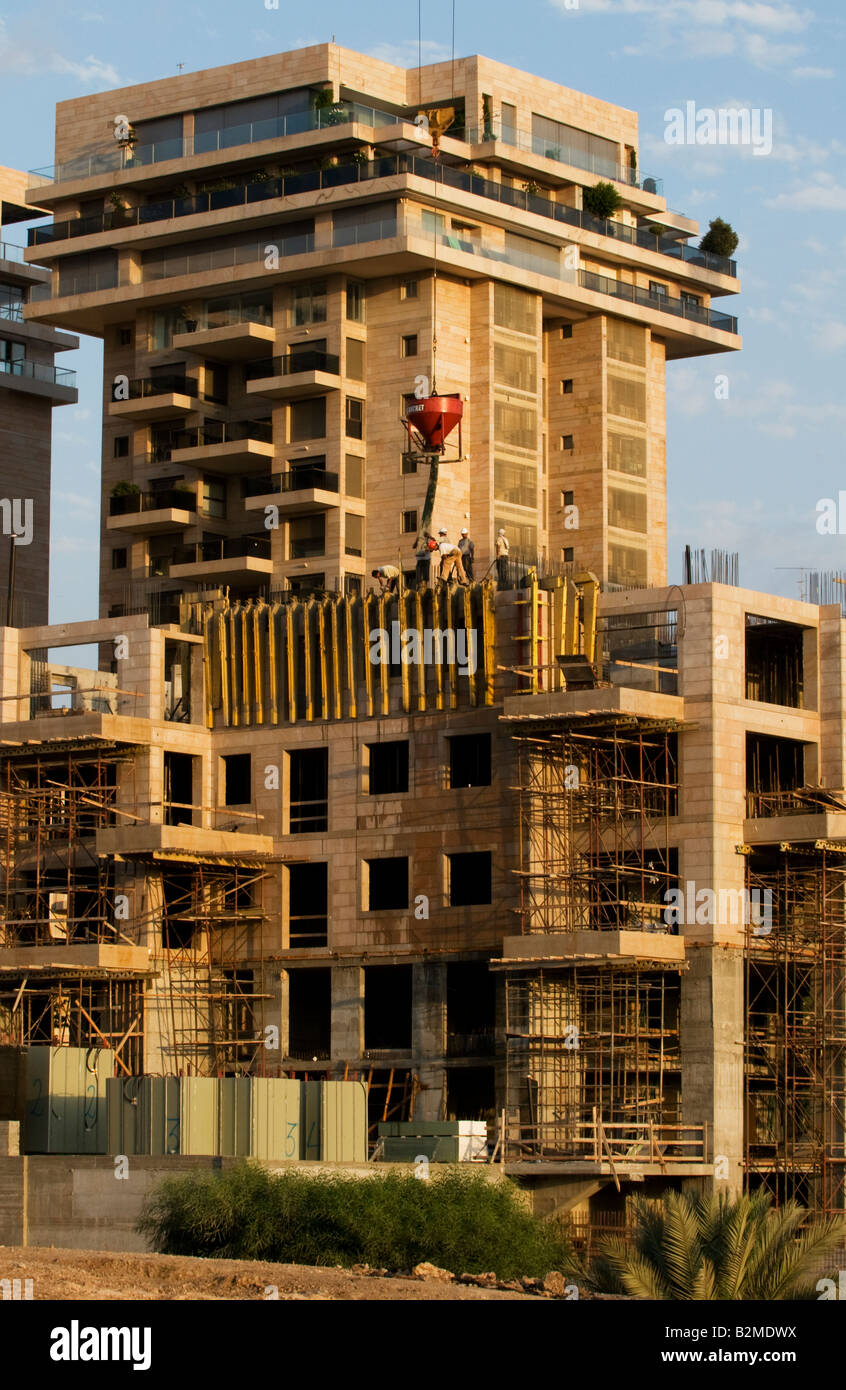 Construction crew casting concrete for the floor of a new apartment ...