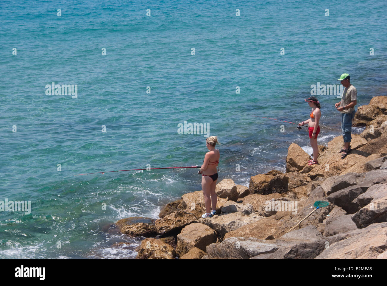 Costa Blanca Spain Benidorm fishing from the rocks Stock Photo - Alamy