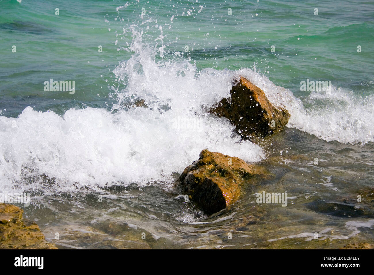 Splash of the waves against the rocks at sea Stock Photo - Alamy
