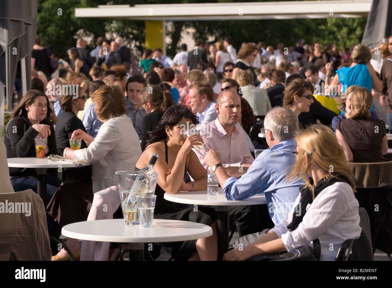 People relax and enjoy a drink on a terrace by Royal Festival Hall ...