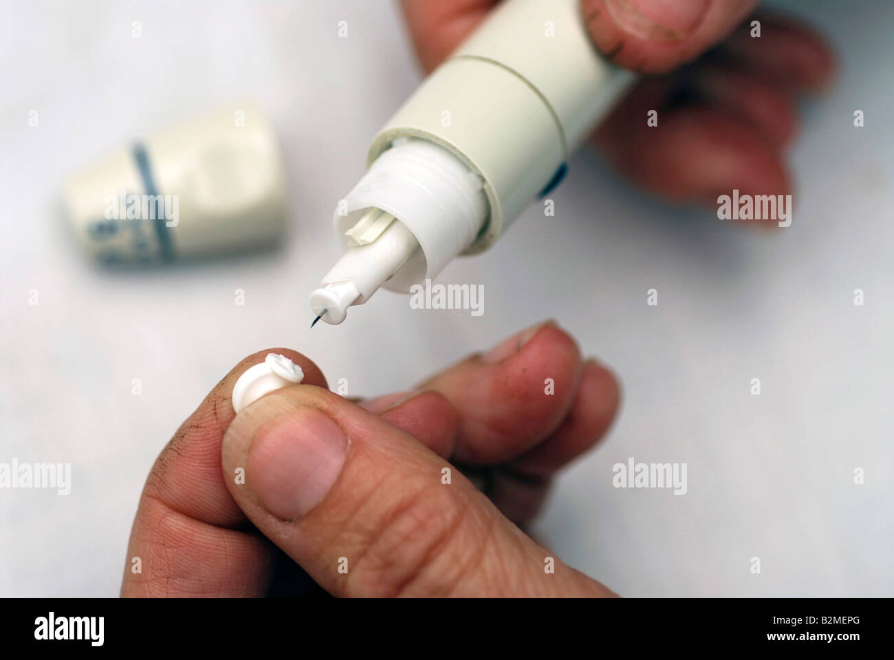 Diabetic breaking off protective cap of lancet in lancet applicator
