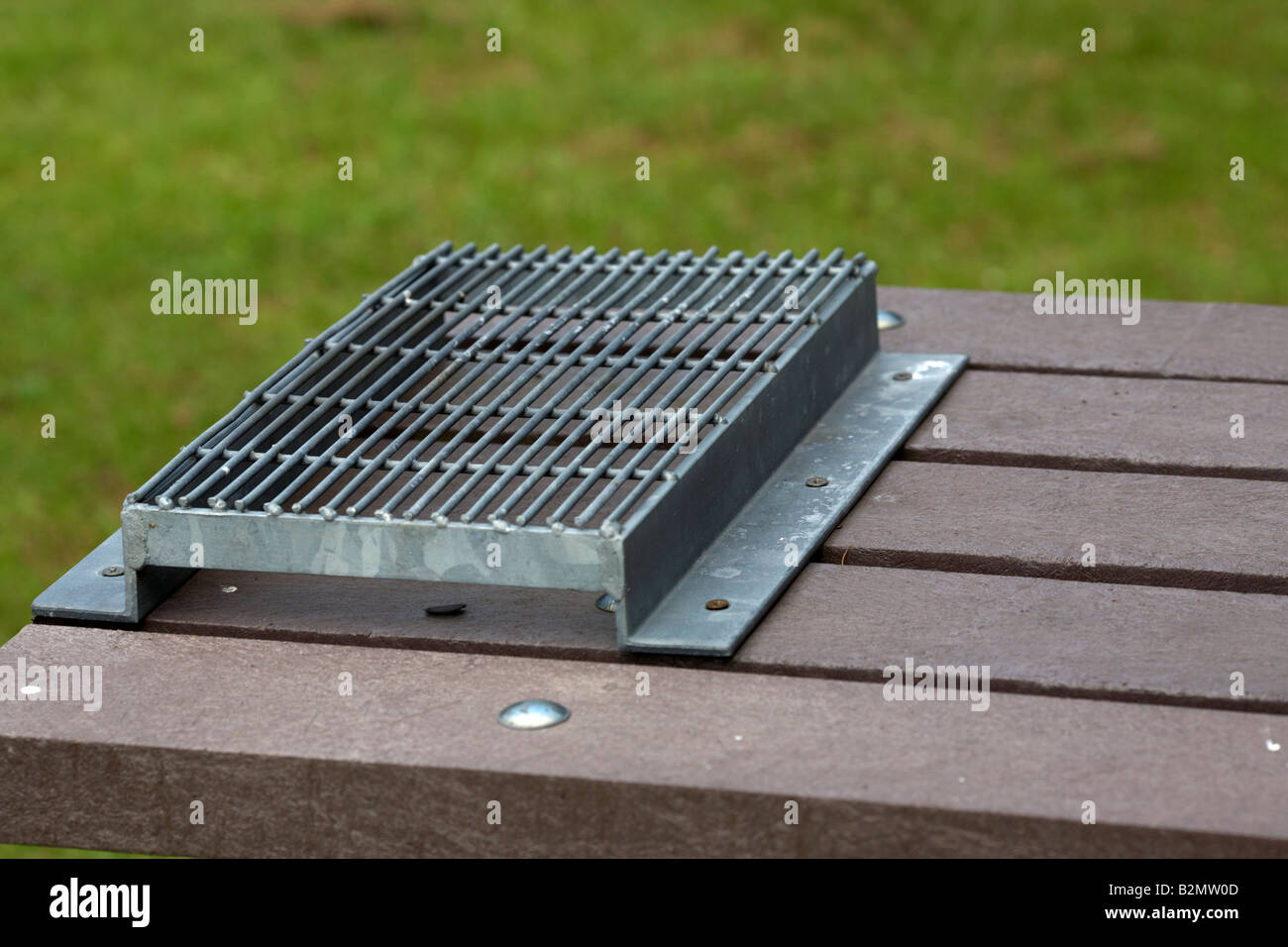 wire mesh attached to modern picnic table to avoid burning by portable