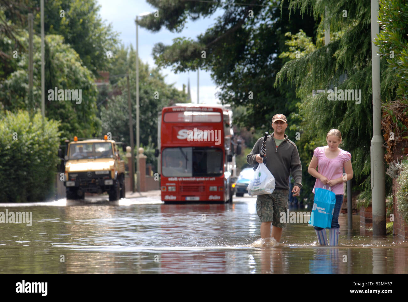 A BUS STOPS BESIDE A FLOOD ON TEWKESBURY ROAD IN LONGFORD GLOUCESTER
