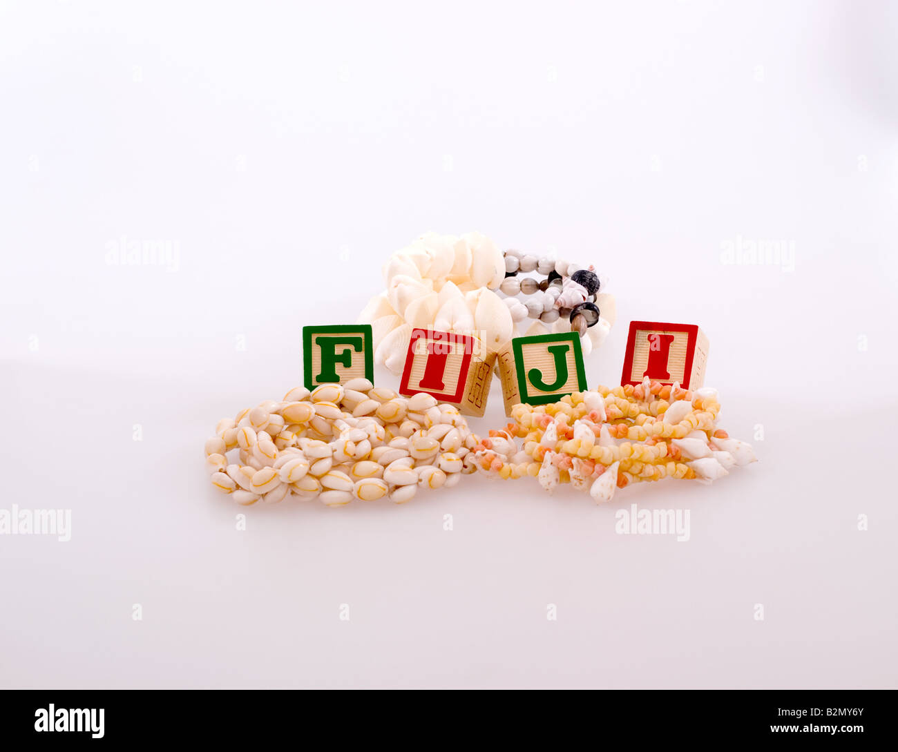 Three shell necklaces with childrens blocks spelling Fiji Stock Photo