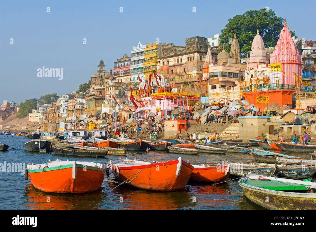 People perform their daily bathing and prayer rituals around ...