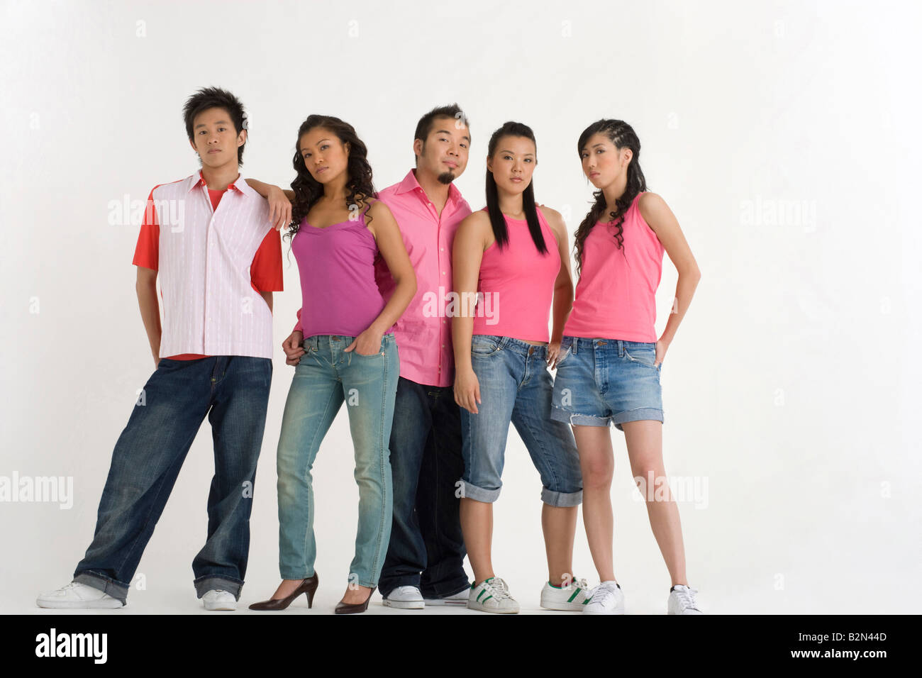 Two young men with three young women standing together Stock Photo - Alamy