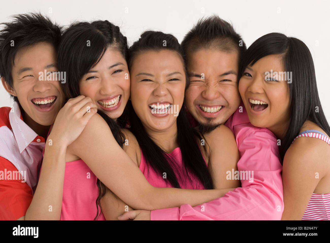 Portrait of two young men with three young women smiling Stock Photo ...