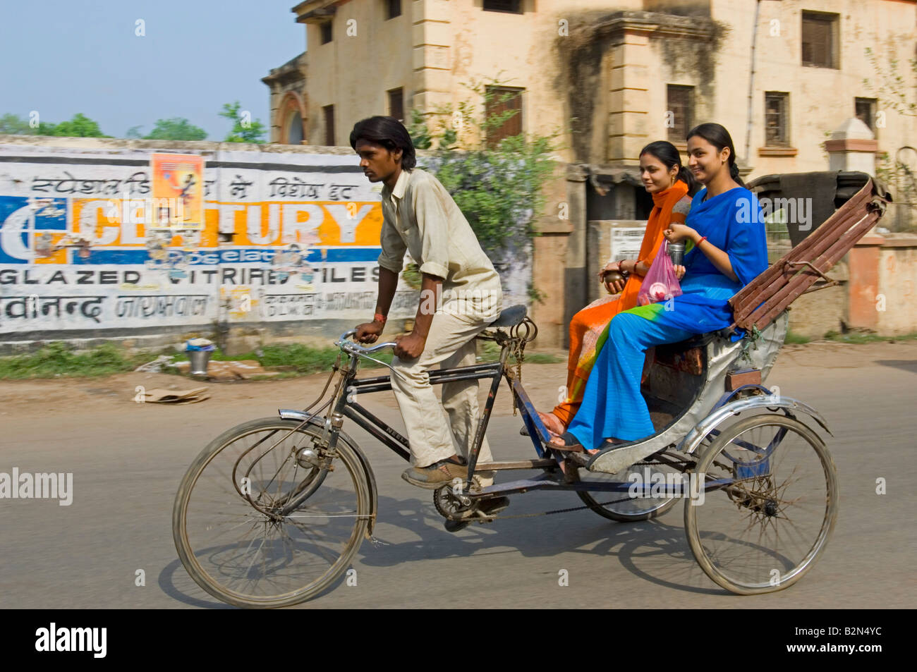 Two attractive Indian women on a cycle rickshaw in Varanasi. Slow ...