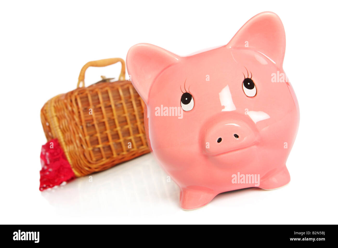 pink piggybank with suitcase packed for vacation moving house leaving Stock Photo