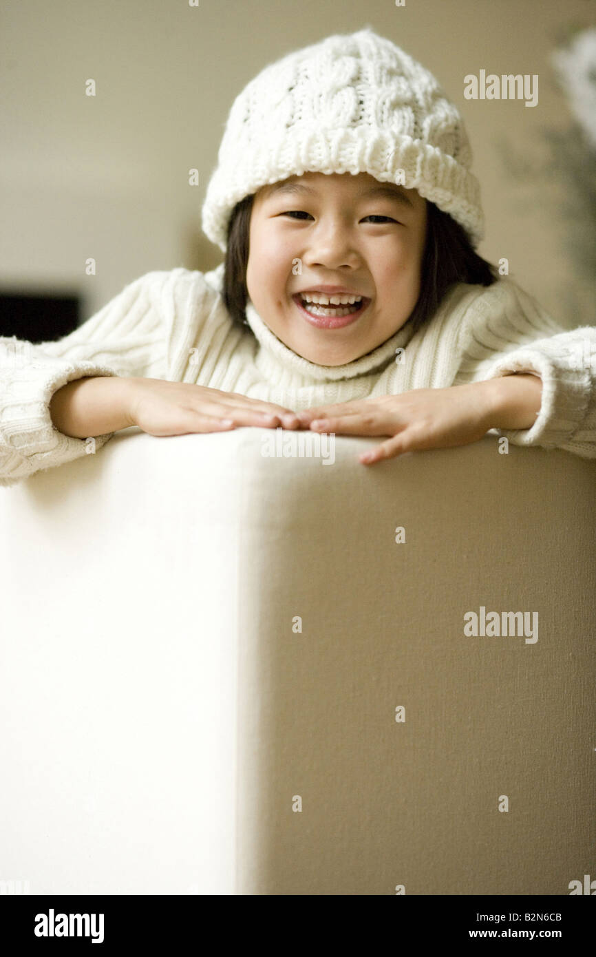 Portrait of a smiling girl on couch Stock Photo - Alamy